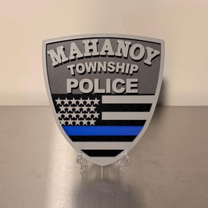 May include: A white ceramic mug with a black handle and the text "But First, Coffee" in a black, bold font. The mug is on a white surface.