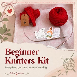 Könnte beinhalten: Ein Strickset mit einem Knäuel roter Wolle, Rundstricknadeln und einem Aufkleber, der eine Katze und eine strickende Person mit dem Text 'cool girls have cool hobbies' zeigt. Ein braunes Etikett trägt die Aufschrift 'made with'.