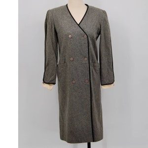 May include: A gray double-breasted coat with black trim and buttons. The coat has a V-neck and long sleeves. The cuffs are cream-colored. The coat is displayed on a mannequin.