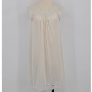 May include: A white sleeveless nightgown with a lace trim around the neckline and the hem. The nightgown is made of a soft, lightweight fabric.