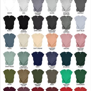 May include: Colour chart displaying 36 different Bella Canvas 3001 unisex t-shirt colours. The colours are arranged in rows and columns, with the names of each colour listed below the corresponding shirt.