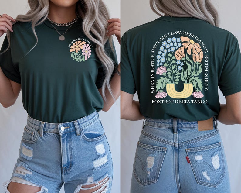 May include: Dark green t-shirt with a floral design on the front and back. The front features a circular design with flowers and the text "FOXTROT DELTA TANGO." The back displays a floral arrangement and the text "WHEN INJUSTICE BECOMES LAW, RESISTANCE BECOMES DUTY."