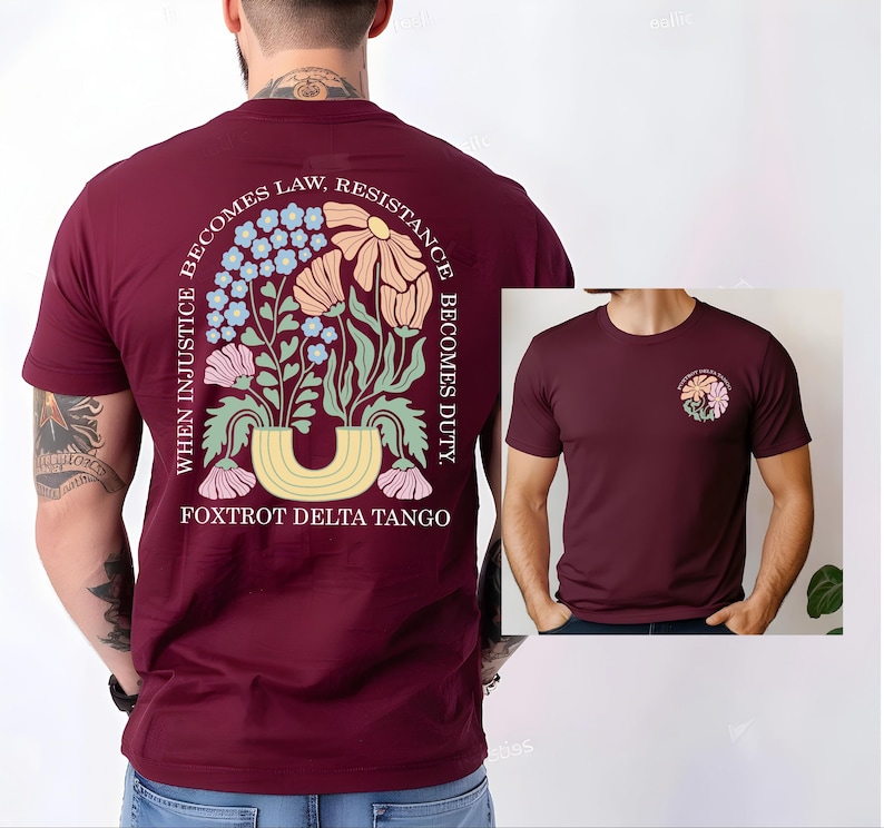 May include: Burgundy t-shirt with a floral design on the back and a smaller version on the front. The back design features flowers, leaves, and the text "WHEN INJUSTICE BECOMES LAW, RESISTANCE BECOMES DUTY. FOXTROT DELTA TANGO."