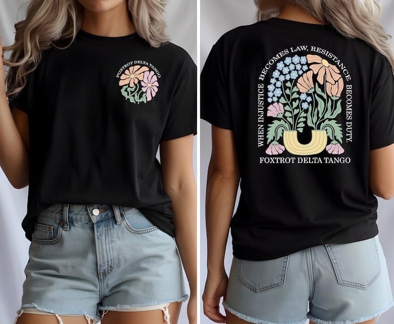 May include: Black t-shirt with a floral design and the text "FOXTROT DELTA TANGO." The back of the shirt features a larger floral arrangement and the quote, "WHEN INJUSTICE BECOMES LAW, RESISTANCE BECOMES DUTY."