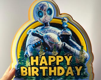May include: A yellow and blue birthday card featuring a robot and a small bird. The card reads "Happy Birthday" in yellow lettering.