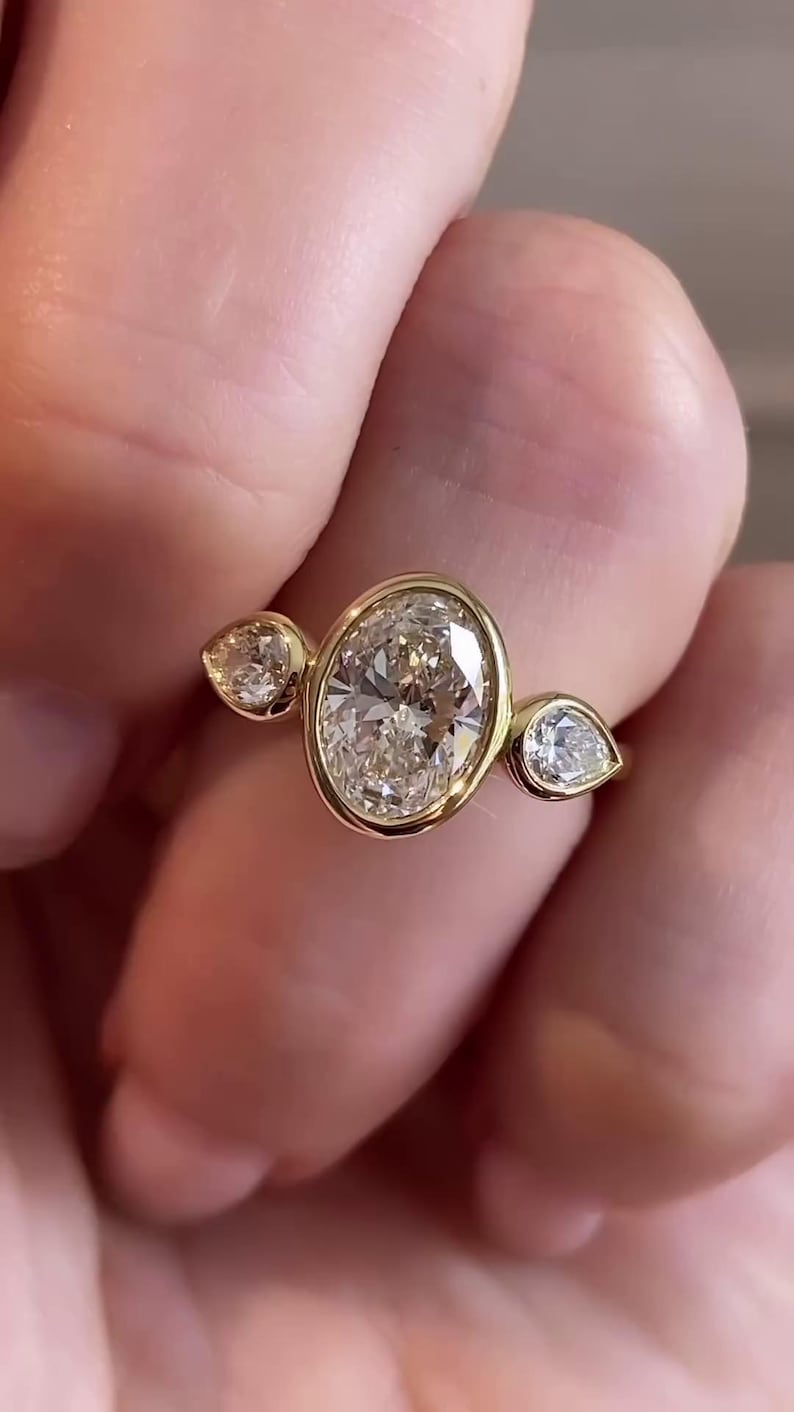 Bezel Setting Oval Cut Moissanite Three Stone Engagement Ring, Side East To West Pear Stone, 18k Solid Gold Band, Sparkling Trilogy Ring image 1
