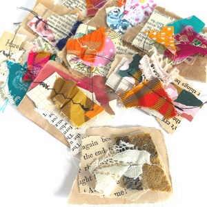 May include: A selection of small fabric and paper pieces in various colours and textures. The collection includes floral prints, polka dots, and plaid patterns. Some pieces feature text from old book pages, creating a collage effect.