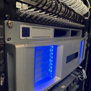 May include: A white ceramic mug with a black handle and the text "But First, Coffee" in a bold, black font. The mug is set against a neutral background, highlighting its simple design.