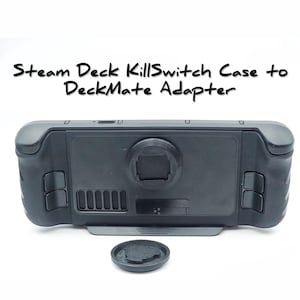 May include: Black Steam Deck KillSwitch Case with a black DeckMate adapter. The case has a cutout for the camera lens and a textured grip.