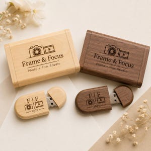May include: Two rectangular wooden boxes and two matching wooden USB flash drives. One set is light maple, the other is dark walnut. Each item is engraved with the text Frame & Focus Photo + Film Studio or FF 2025 with camera and film icons.