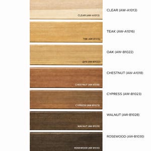 May include: A color chart displaying wood stain samples in various shades, including white, clear, teak, oak, chestnut, cypress, walnut, rosewood, and wenge. Each sample is labeled with its name and a corresponding code.