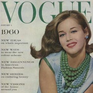 May include: Vogue magazine cover from January 1, 1960, featuring a woman with blonde hair, wearing a light blue dress and multiple strands of green and blue beaded necklaces. The magazine title is in green, with the year 1960 below.
