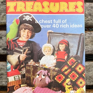 May include: A Patons Treasures pattern book with a cover featuring a child in a pirate costume, a treasure chest, dolls, and various knitted items. The text reads Patons Treasures, 184, Price Code H, and a chest full of over 40 rich ideas.