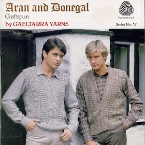 May include: Image of two men wearing knitted Aran sweaters. The sweaters are light gray and brown, with intricate cable knit patterns. The image also features text that reads "Aran and Donegal Craftspun by GAELTARRA YARNS."