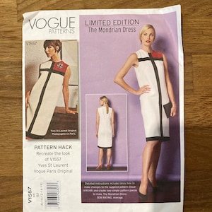 May include: A Vogue Patterns sewing pattern envelope for The Mondrian Dress, style V1557. The front features images of a sleeveless white shift dress with black vertical and horizontal lines and a red colour block, plus text including Yves St Laurent.