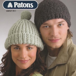 May include: Image of two knitted hats. One is light green with a pom-pom, the other is dark gray. The hats are part of a Patons leaflet, as indicated by the logo and text at the top. The hats are worn by two people.