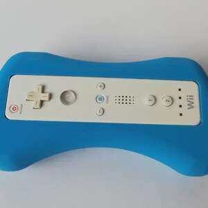 May include: A blue controller grip housing a white Wii remote. The remote has a directional pad, buttons, and the Wii logo. The grip is a solid, curved shape, designed for comfortable handling during gameplay.