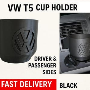 May include: Black VW T5 cup holder with the VW logo. The cup holder is designed for the driver and passenger sides. The text "VW T5 CUP HOLDER" is at the top of the image. The text "DRIVER & PASSENGER SIDES" is below the cup holder.