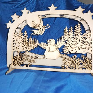 Candle arch with snowman in the fairy forest