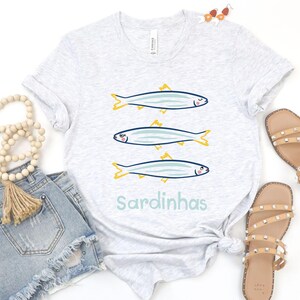 Cute sardines t-shirt is perfect for seafood lovers, beachgoers, and anyone who enjoys a touch of Portuguese sardine art in their wardrobe