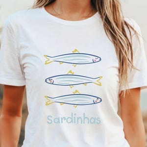 A playful and stylish sardine illustration featuring three charming sardines with girly expressions, outlined in bold colors. Perfect for ocean lovers, seafood fans, and those who appreciate quirky, artistic designs.