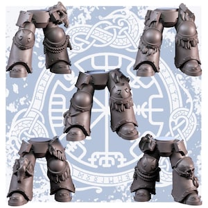 May include: Several gray, detailed miniature leg armor pieces, possibly for tabletop gaming or model building. Each piece features intricate designs, including knee pads, fur-like accents, and decorative elements. The background has a light blue pattern.