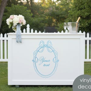 May include: A white bar with a blue decorative design and the text "Your text". The bar has a bouquet of flowers, champagne, and glasses on top. A vinyl decal is also included.