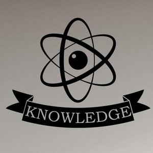 May include: Black and white vinyl wall decal featuring an atom symbol with the word "KNOWLEDGE" on a banner underneath. The decal is displayed on a white wall in a classroom setting with wooden desks.