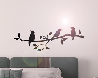 May include: Silhouette of four birds perched on a branch with leaves. The birds are facing different directions. The image is in black and white and is set against a white background.