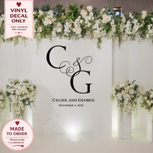 May include: A white wall featuring a black monogram of the letters C and G, with the names "CELINE AND GEORGE" and the date "NOVEMBER 4, 2025" beneath. The words "VINYL DECAL ONLY" and "MADE TO ORDER" are also visible.
