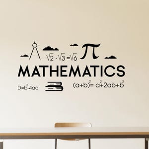 May include: Black and white wall decal with the word "MATHEMATICS" and various mathematical symbols and equations, including the square root of 2 multiplied by the square root of 3 equals the square root of 6, pi, and the formula for a squared plus b squared. The decal is on a white wall with a wooden table and chair in the foreground.
