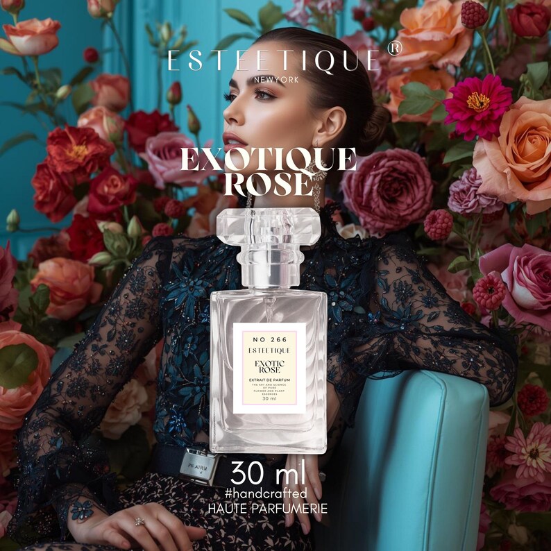 May include: A clear glass perfume bottle with a rectangular shape and a crystal-like cap. The label reads "EXOTIQUE ROSE" and "30 ml". The background features a woman surrounded by roses and the text "ESTEETIQUE NEW YORK".