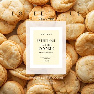 May include: An overhead shot of golden-brown butter cookies surrounds a central label. The label reads "ESTEETIQUE BUTTER COOKIE" with additional text. The perfume bottle contains 30 ml of product. The text "Introducing BUTTER COOKIES" is also visible.