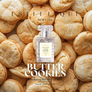 May include: A clear perfume bottle with a rectangular label, surrounded by golden-brown butter cookies. The label reads "ESTETIQUE BUTTER COOKIE" and "50 ml." The words "BUTTER COOKIES" are displayed in large letters below the bottle.
