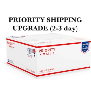 May include: A white USPS Priority Mail flat rate box with red trim and the text "PRIORITY SHIPPING UPGRADE (2-3 day)". The box also features the text "PRIORITY MAIL" and "TRACKED * INSURED *".