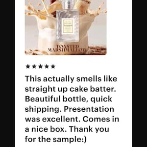May include: A perfume bottle with the text "TOASTED MARSHMALLOW" is displayed in a splash of cream and brown. The bottle is clear with a rectangular shape and a silver cap. The brand name "ESTETIQUE" is visible.