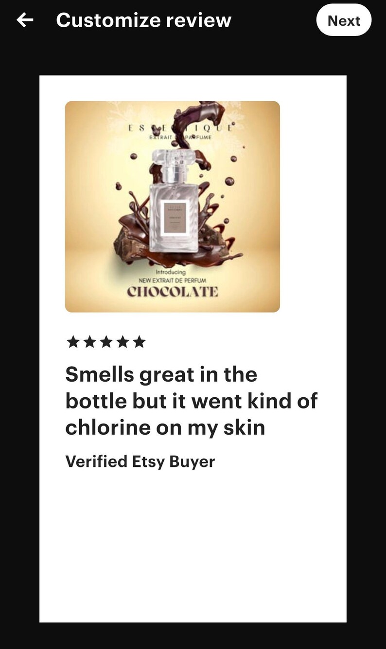 May include: A perfume bottle with a clear glass body and a clear cap, set against a backdrop of chocolate-colored liquid and splashes. The label reads "CHOCOLATE" and "NEW EXTRAIT DE PERFUM".