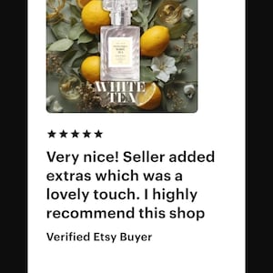May include: A perfume bottle with the text "WHITE TEA" is surrounded by lemons and greenery. The bottle is clear with a silver cap. The image also includes the text "EXTRAIT DE PARFUM".