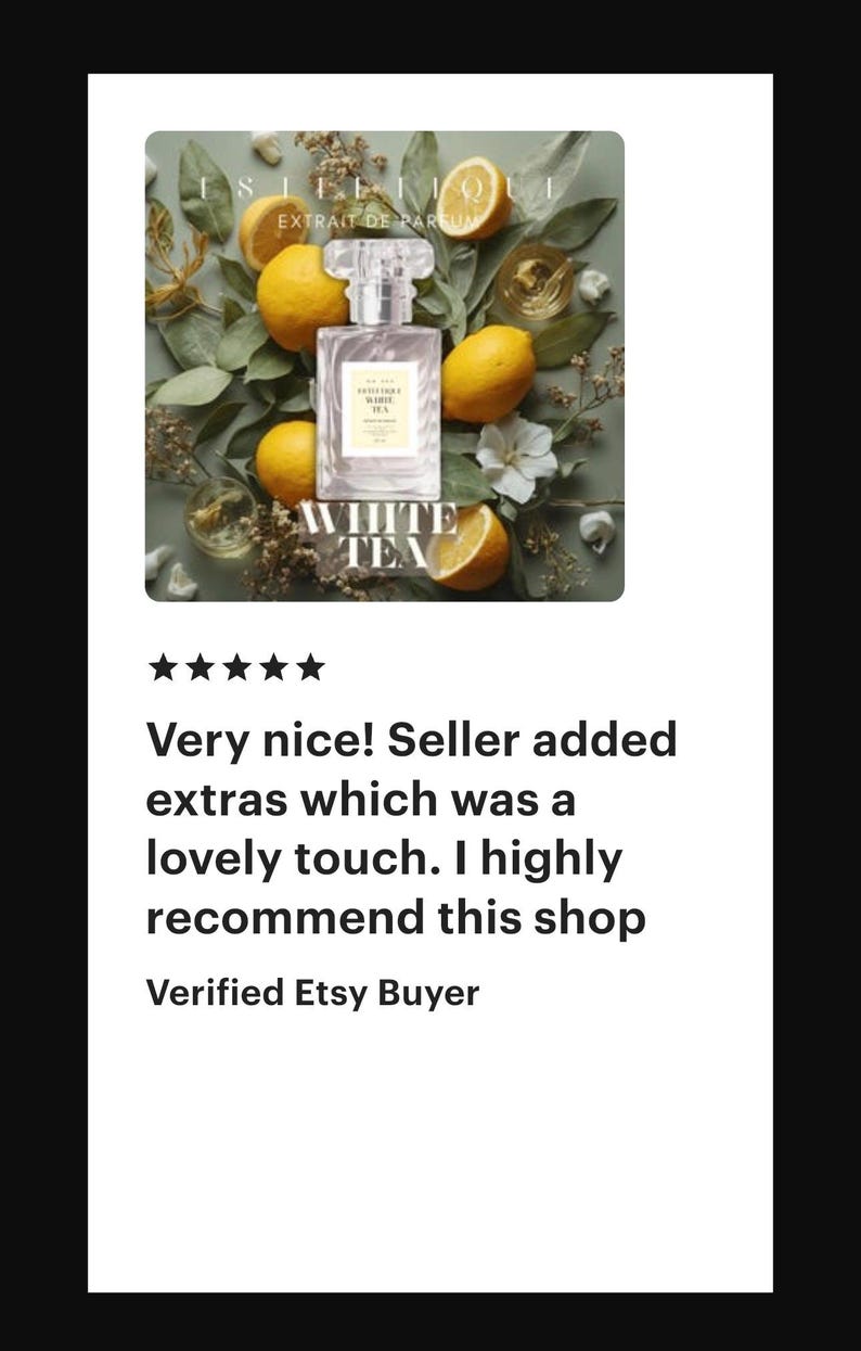 May include: A perfume bottle with the text "WHITE TEA" is surrounded by lemons and greenery. The bottle is clear with a silver cap. The image also includes the text "EXTRAIT DE PARFUM".