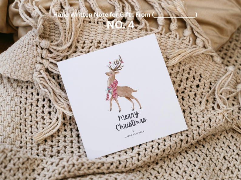 May include: A white greeting card with a watercolor illustration of a reindeer wearing a scarf. The card reads "Merry Christmas & Happy New Year." The card is on a beige knitted blanket. Text at the top reads "Hand Written Note for Gift: From ( ) NO. 4."