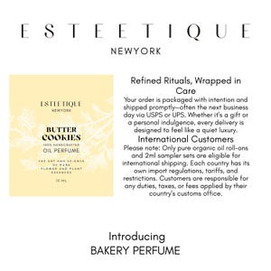 May include: A perfume bottle with the text "BUTTER COOKIES 100% HANDCRAFTED OIL PERFUME" and "THE ART AND SCIENCE OF PURE FLOWER AND PLANT ESSENCES". The brand name "ESTEETIQUE NEWYORK" is at the top. The text "BAKERY PERFUME" is at the bottom.