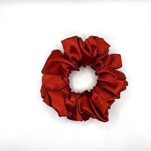 May include: A rust-colored satin scrunchie for hair.