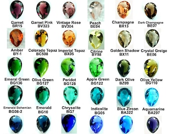 May include: Chart of pear-shaped gemstones in various colors, including wine red, ruby red, rose red, pink, garnet, garnet pink, vintage rose, peach, champagne, dark champagne, amber, Colorado topaz, imperial topaz, citrine, golden shadow, crystal greige, emerald green, olive green, peridot, apple green, dark olive, olive yellow, emerald bohemian, emerald, chrysolite, indicolite, blue zircon, aquamarine, Montana blue, London blue, sapphire, light sapphire, ocean blue, tanzanite, amethyst, violet, diamond clear, black diamond, jet black, and smokey.