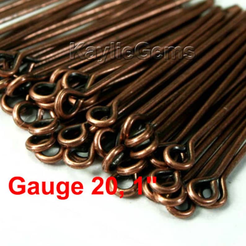 May include: A close-up of a pile of copper-colored, 1-inch long head pins with a loop at one end. The text "Gauge 20, 1"" is visible in the image.