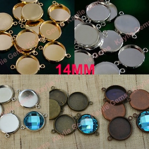 May include: Assortment of 14mm round metal bezel settings with three loops for hanging. The bezels are shown in gold, silver, and copper finishes.