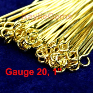 May include: A close-up of a pile of gold-colored, 1-inch long jump rings. The rings are 20 gauge and have a loop on one end. The text "Gauge 20, 1" is visible in the image.