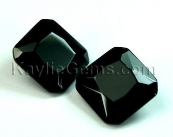 May include: Two black gemstone beads in a square shape with beveled edges.