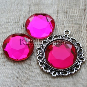May include: Three pink faceted glass gems, two are loose and one is set in a silver filigree pendant.