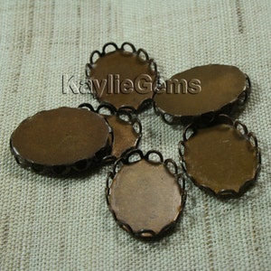 May include: Five antique bronze oval-shaped metal bezel settings with a scalloped edge. The bezels are perfect for adding a vintage touch to jewelry making projects.