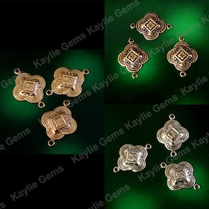 May include: Eight gold-toned metal connector charms with a decorative floral design. Each charm has two jump rings for attaching to jewelry or other crafts.